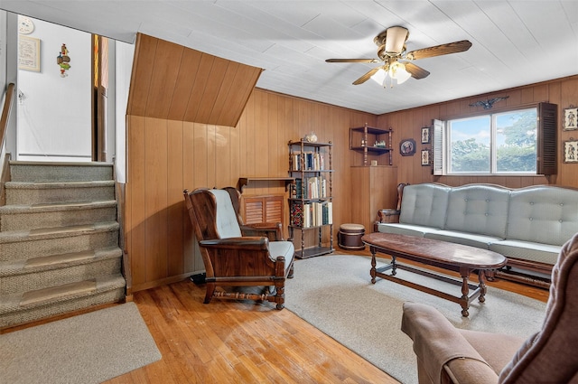 5 Clark St, Plainview, NY 11803 - living area with ceiling fan, wood walls, light wood-style flooring, and stairs