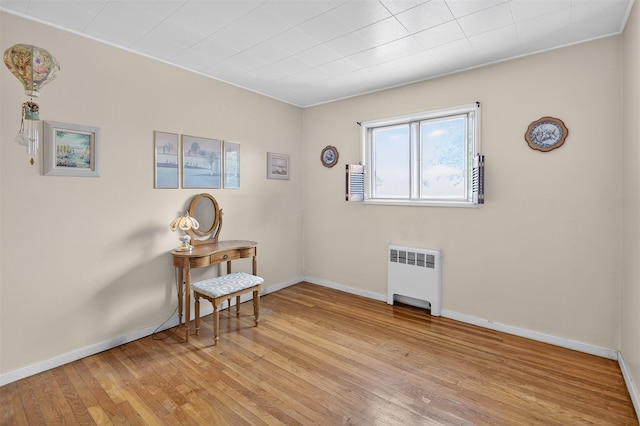 5 Clark St, Plainview, NY 11803 - spare room featuring radiator heating unit and light wood-style floors