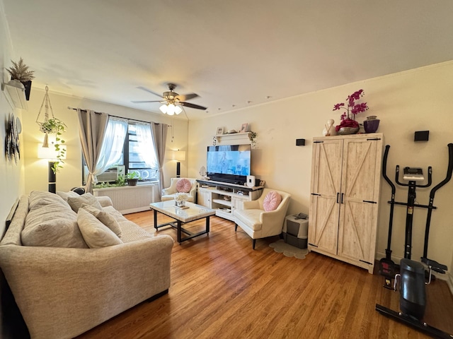 2208 76th St Unit A3, East Elmhurst, NY 11370 - living room with wood finished floors, a ceiling fan, and radiator heating unit