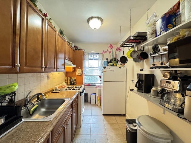 2208 76th St Unit A3, East Elmhurst, NY 11370 - kitchen with white appliances, under cabinet range hood, backsplash, and light tile patterned flooring