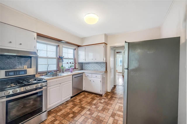 73 Bismark Ave, Valley Stream, NY 11581 - kitchen featuring stainless steel appliances, white cabinets, light countertops, brick patterned floors, and under cabinet range hood
