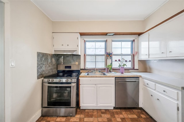 73 Bismark Ave, Valley Stream, NY 11581 - kitchen with stainless steel appliances, under cabinet range hood, white cabinets, tasteful backsplash, and crown molding