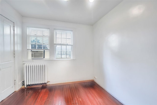 73 Bismark Ave, Valley Stream, NY 11581 - unfurnished room with radiator, cooling unit, and wood finished floors