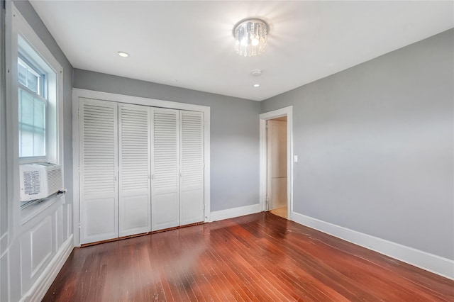 73 Bismark Ave, Valley Stream, NY 11581 - unfurnished bedroom with wood finished floors, a closet, a chandelier, cooling unit, and recessed lighting