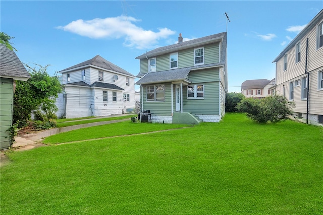 73 Bismark Ave, Valley Stream, NY 11581 - rear view of house with a yard and a chimney