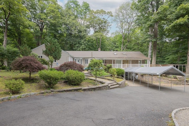 23 Sky Meadow Rd, Suffern, NY 10901 - view of front of home with a carport, a chimney, and view of wooded area