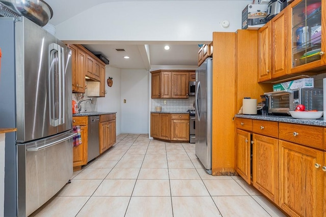 23 Sky Meadow Rd, Suffern, NY 10901 - kitchen featuring appliances with stainless steel finishes, brown cabinetry, tasteful backsplash, and light tile patterned floors