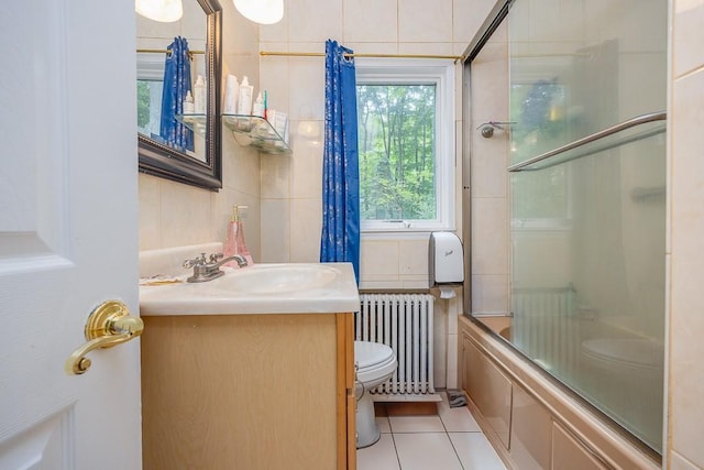 23 Sky Meadow Rd, Suffern, NY 10901 - full bath featuring radiator, tile patterned flooring, vanity, shower / bath combination with glass door, and tile walls