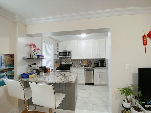 141-35 79th Ave Unit 3M, Flushing, NY 11367 - kitchen featuring appliances with stainless steel finishes, light marble finish flooring, white cabinetry, a peninsula, and light stone counters