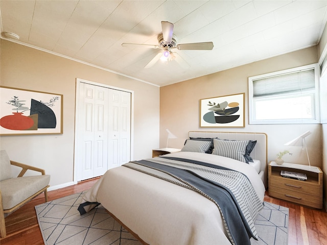 246 15th St, West Babylon, NY 11704 - bedroom with wood finished floors, ornamental molding, a closet, and a ceiling fan
