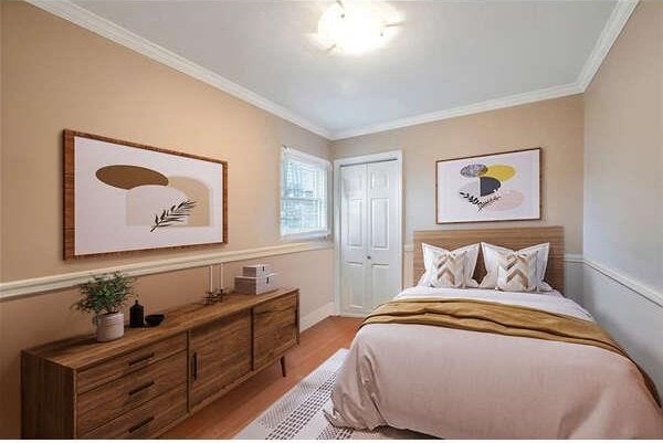246 15th St, West Babylon, NY 11704 - bedroom with wood finished floors, crown molding, and a closet