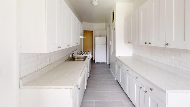 151 Prospect Unit 3-F, Mount Vernon, NY 10550 - kitchen featuring decorative backsplash, white appliances, white cabinetry, and light tile patterned floors