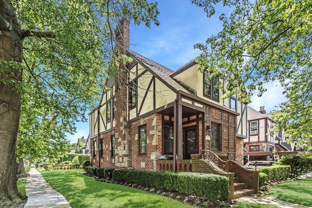 25 Reyam Rd, Lynbrook, NY 11563 - view of side of property featuring stucco siding, a yard, and brick siding