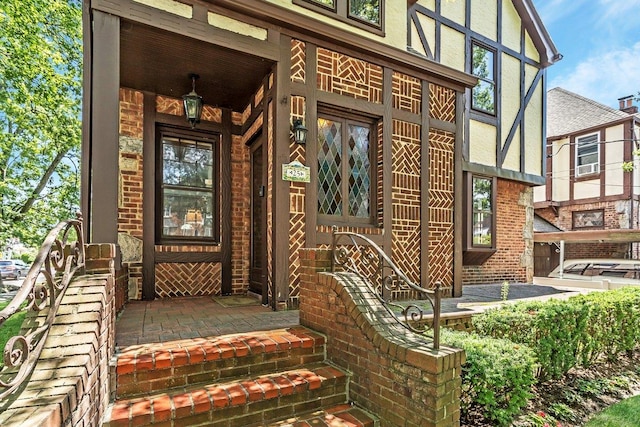 25 Reyam Rd, Lynbrook, NY 11563 - view of exterior entry featuring covered porch, stucco siding, and brick siding