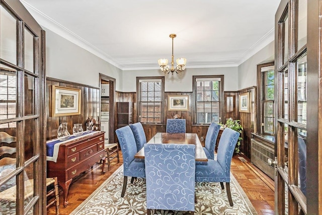 25 Reyam Rd, Lynbrook, NY 11563 - dining area featuring a chandelier, wainscoting, wood walls, and crown molding
