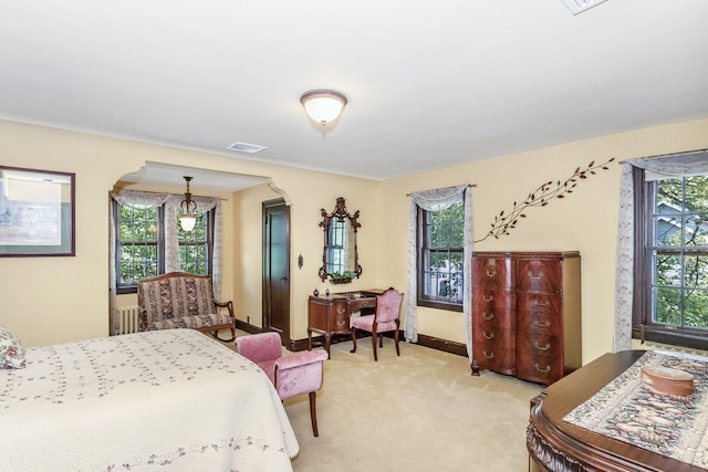 25 Reyam Rd, Lynbrook, NY 11563 - bedroom with multiple windows, light colored carpet, radiator heating unit, and arched walkways