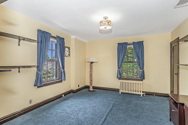 25 Reyam Rd, Lynbrook, NY 11563 - unfurnished bedroom featuring radiator heating unit, carpet floors, and multiple windows