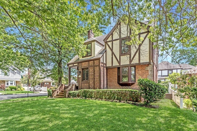 25 Reyam Rd, Lynbrook, NY 11563 - view of front of house with brick siding, a front lawn, and stucco siding