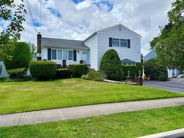 107 Intervale Ave, Farmingdale, NY 11735 - tri-level home with a front lawn, a chimney, and a porch