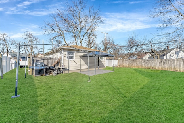 1002 Park Ave, Westbury, NY 11590 - rear view of property with a fenced backyard, an outdoor structure, and a patio