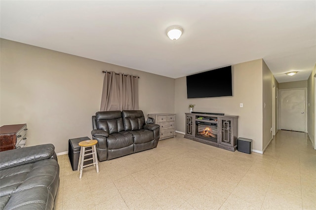 1002 Park Ave, Westbury, NY 11590 - living room featuring a glass covered fireplace and light floors