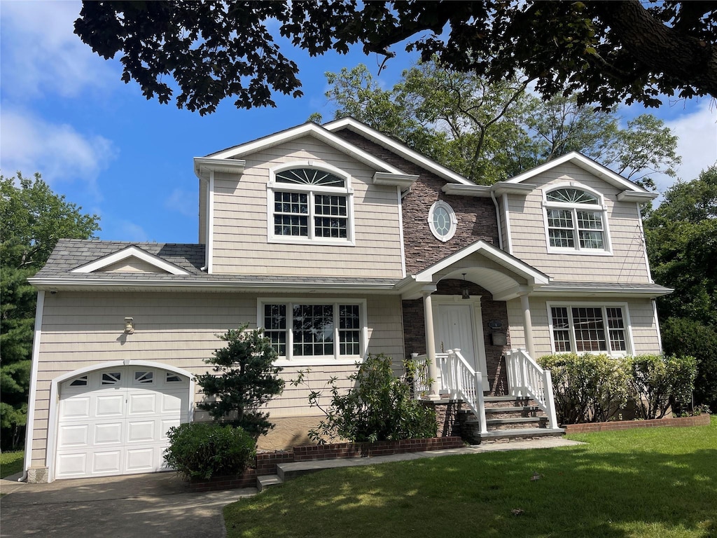 8 Trezza Ct, Bellmore, NY 11710 - view of front of house featuring a front lawn, a garage, driveway, stone siding, and roof with shingles