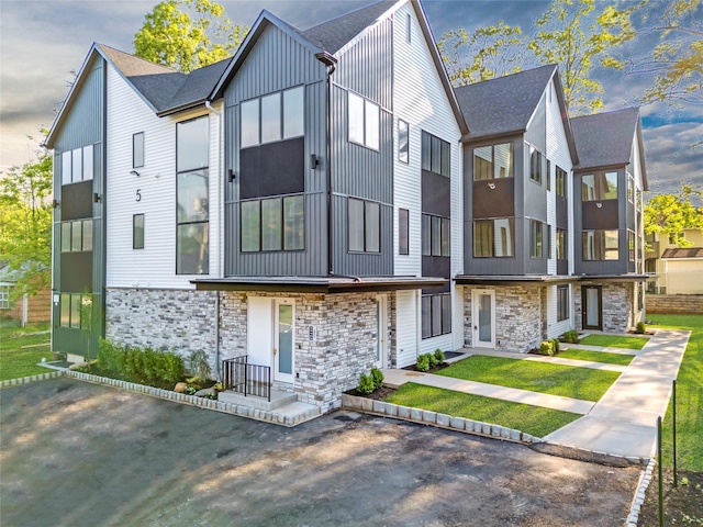 5 Francis Pl Unit 214, Monsey, NY 10952 - contemporary house with stone siding, roof with shingles, and board and batten siding