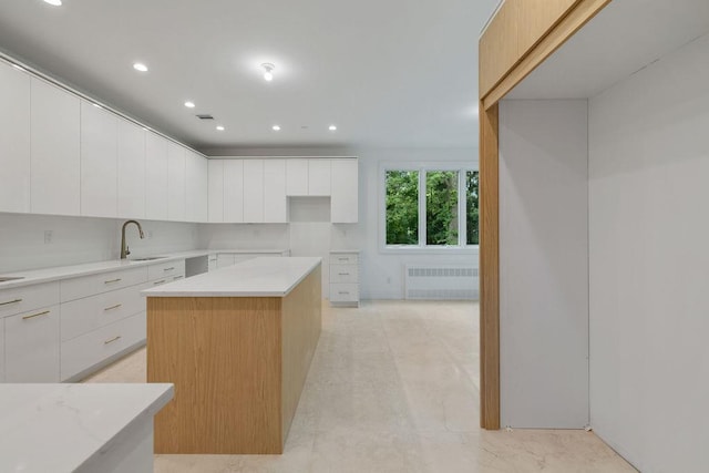 5 Francis Pl Unit 214, Monsey, NY 10952 - kitchen with radiator heating unit, modern cabinets, recessed lighting, white cabinets, and light stone countertops
