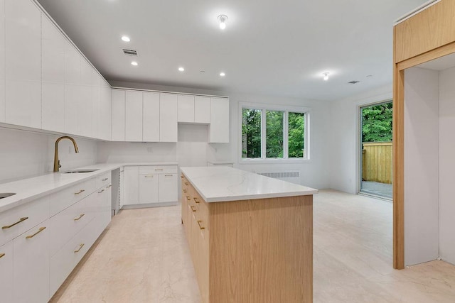 5 Francis Pl Unit 214, Monsey, NY 10952 - kitchen featuring radiator, a center island, light stone countertops, modern cabinets, and recessed lighting
