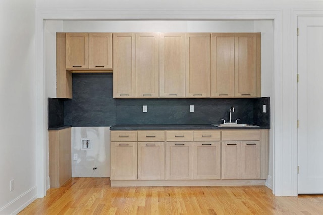 5 Francis Pl Unit 214, Monsey, NY 10952 - kitchen featuring light wood-style flooring, dark countertops, tasteful backsplash, and light brown cabinetry