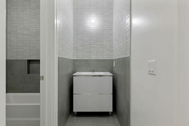 5 Francis Pl Unit 214, Monsey, NY 10952 - bathroom with vanity, a tub, and tile walls
