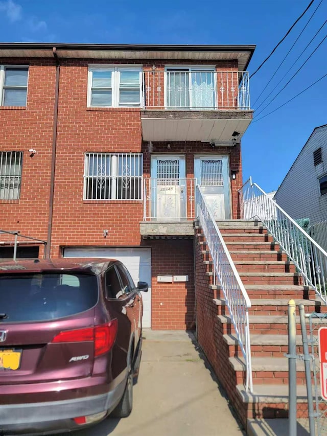 20-45 120th St, College Point, NY 11356 - view of front facade featuring brick siding, an attached garage, and stairway