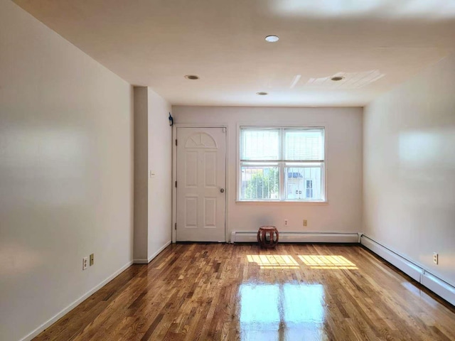 20-45 120th St, College Point, NY 11356 - empty room with wood finished floors, baseboard heating, and recessed lighting