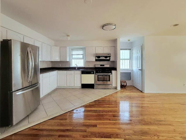 20-45 120th St, College Point, NY 11356 - kitchen with stainless steel appliances, dark countertops, white cabinets, and light wood-type flooring