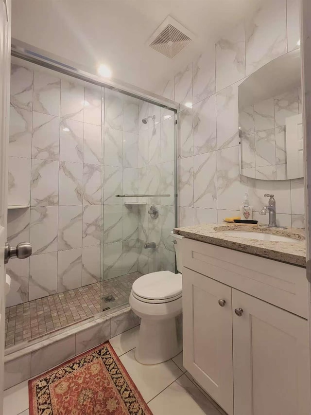 20-45 120th St, College Point, NY 11356 - bathroom featuring vanity, a shower stall, and tile walls