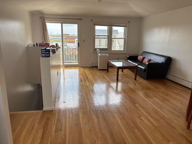 20-45 120th St, College Point, NY 11356 - living area featuring a baseboard radiator, light wood-style flooring, and a baseboard heating unit