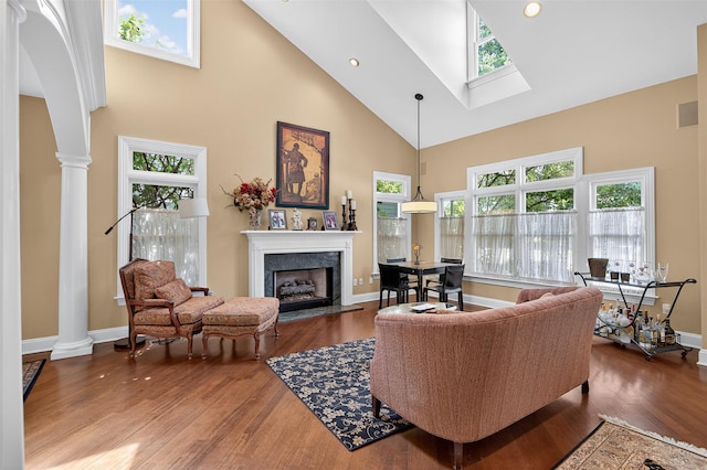 48 Fieldstone Ln, Oyster Bay, NY 11771 - living room with high vaulted ceiling, decorative columns, a high end fireplace, and wood finished floors