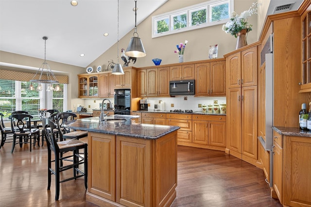 48 Fieldstone Ln, Oyster Bay, NY 11771 - kitchen featuring high vaulted ceiling, black appliances, glass insert cabinets, backsplash, and an island with sink