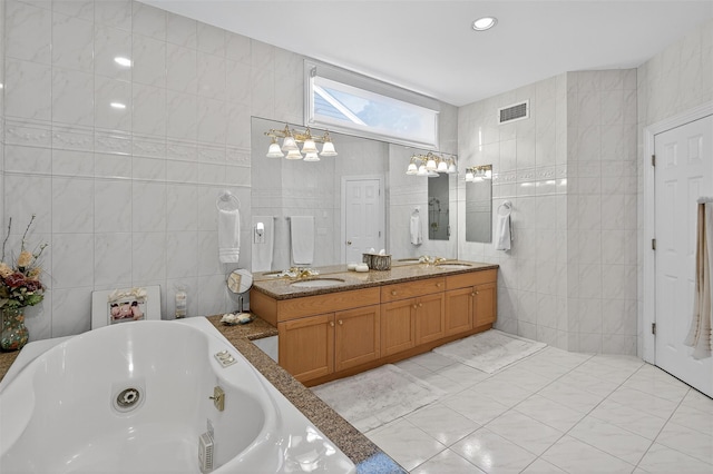 48 Fieldstone Ln, Oyster Bay, NY 11771 - bathroom with tile walls, double vanity, a whirlpool tub, and a chandelier