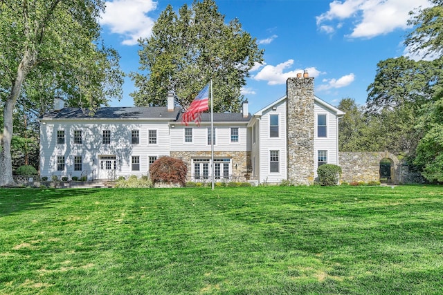 36 Bush Creek Ln, Poughquag, NY 12570 - back of house with a chimney, stone siding, and a lawn