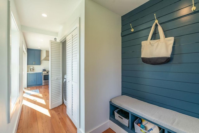 1030 Horseshoe Dr, Cutchogue, NY 11935 - mudroom with light wood-style floors, wooden walls, washer / clothes dryer, and recessed lighting