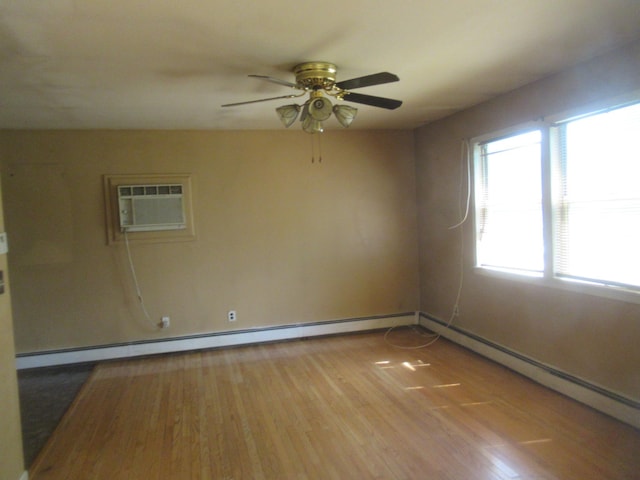 109 Indian Trl, Montgomery, NY 12543 - empty room with an AC wall unit, wood finished floors, a ceiling fan, and a baseboard radiator