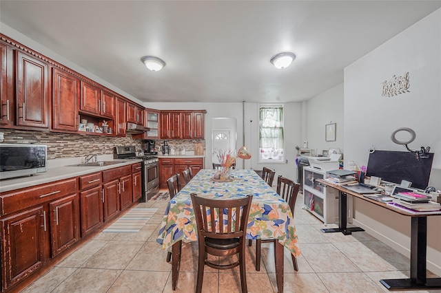 1285A Saint Marks Ave, Brooklyn, NY 11213 - kitchen featuring light countertops, stainless steel appliances, light tile patterned floors, tasteful backsplash, and glass insert cabinets