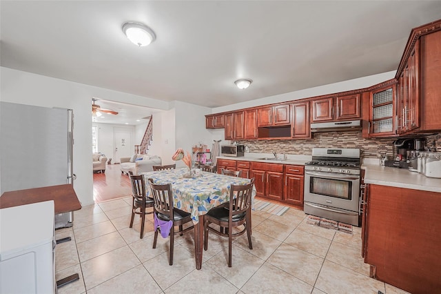 1285A Saint Marks Ave, Brooklyn, NY 11213 - kitchen with stainless steel appliances, decorative backsplash, light countertops, and light tile patterned floors