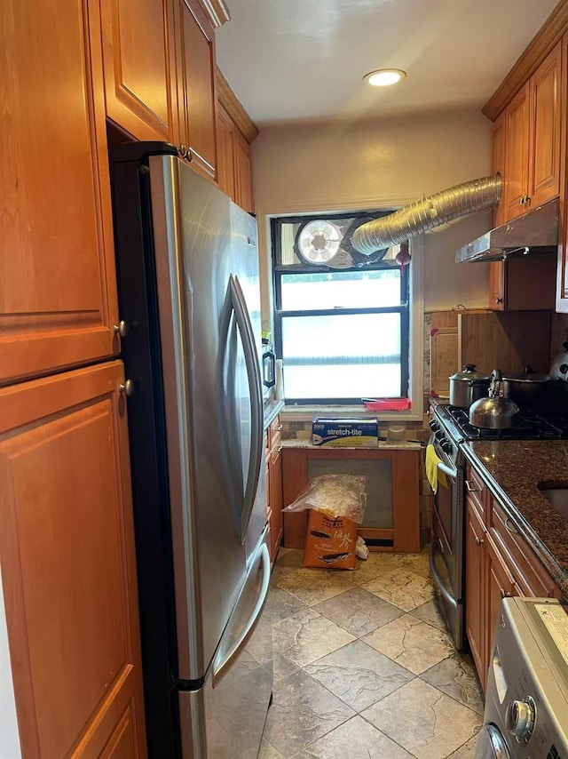 67-12 197th St Apt 1, Fresh Meadows, NY 11365 - kitchen with appliances with stainless steel finishes, under cabinet range hood, brown cabinets, light stone finish flooring, and recessed lighting