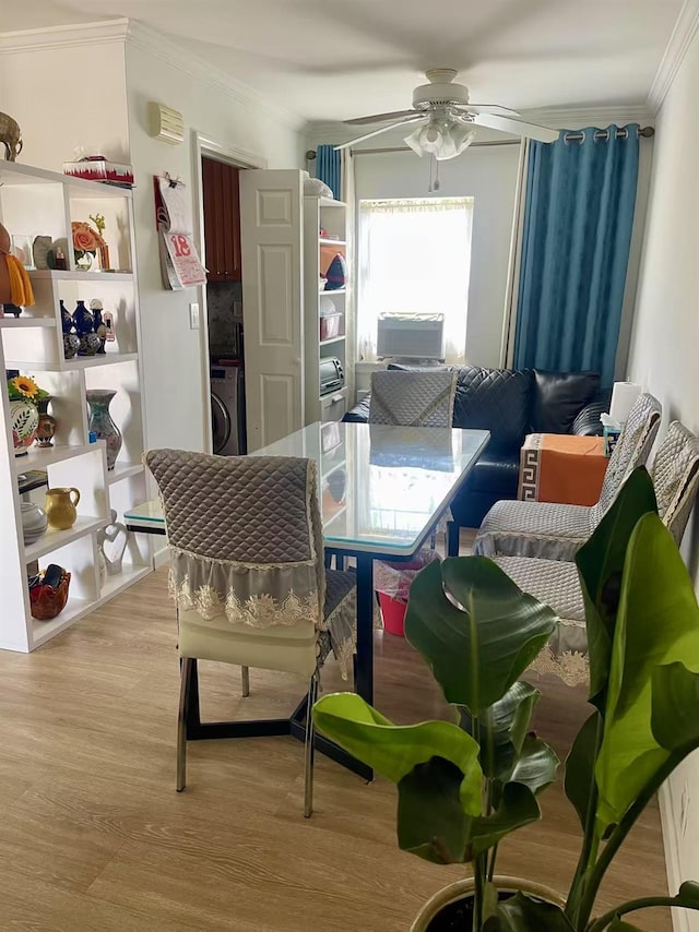 67-12 197th St Apt 1, Fresh Meadows, NY 11365 - dining room featuring ornamental molding, washer / dryer, ceiling fan, and wood finished floors