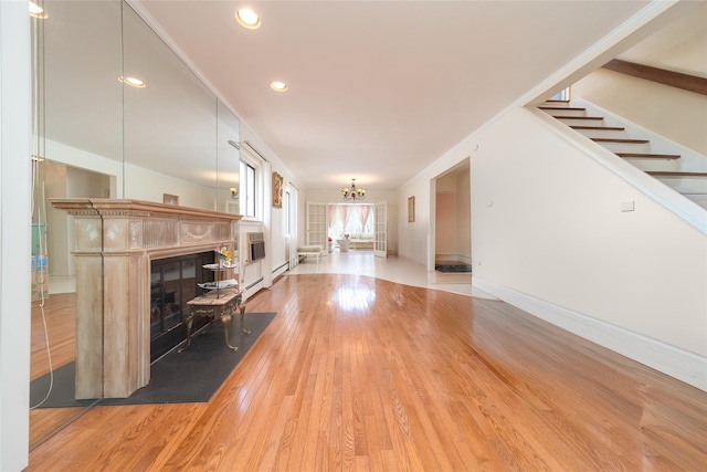 145-67 5th Ave, Whitestone, NY 11357 - living area featuring a fireplace, wood-type flooring, a chandelier, stairway, and recessed lighting