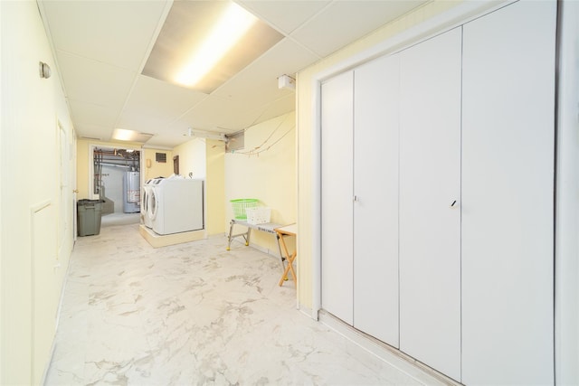 145-67 5th Ave, Whitestone, NY 11357 - finished below grade area with washer / dryer, gas water heater, a paneled ceiling, and light marble finish flooring