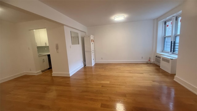 142-20 Franklin Ave Unit 3V, Flushing, NY 11355 - spare room with light wood-type flooring and radiator