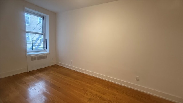 142-20 Franklin Ave Unit 3V, Flushing, NY 11355 - unfurnished room with radiator and wood finished floors